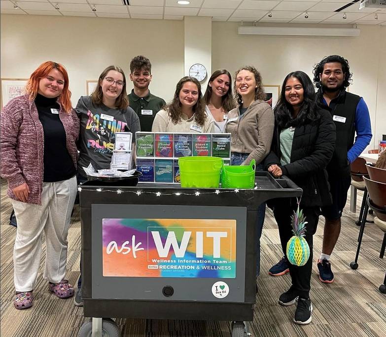 Image of WIT team members smiling behind the WIT resource cart.